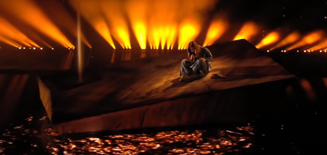 Bulgaria's VICTORIA sitting on a giant cheese slice at Eurovision 2021
