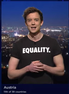 The chap revealing who Austria awarded their points to, with a T-Shirt that reads 'Equality.' (with a full stop)